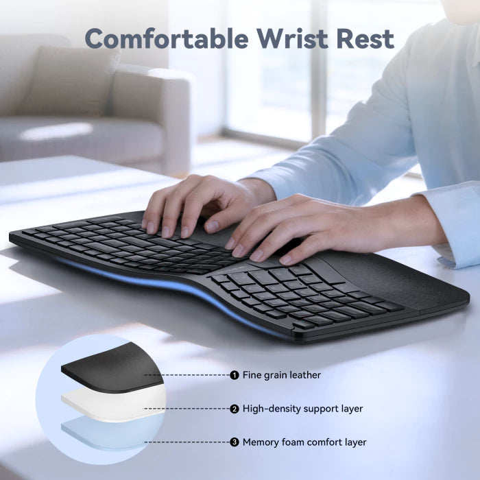 Person using a keyboard with a wrist rest on a desk, showing detailed layers of the wrist rest.